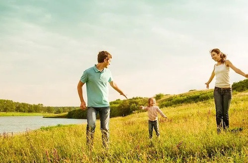Family running on a field